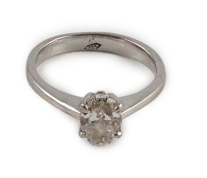 A modern platinum and solitaire oval cut diamond set ring